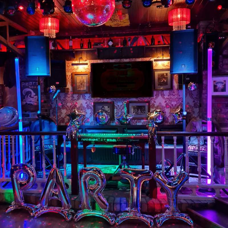 Piano in the middle of a stage with speakers on either side